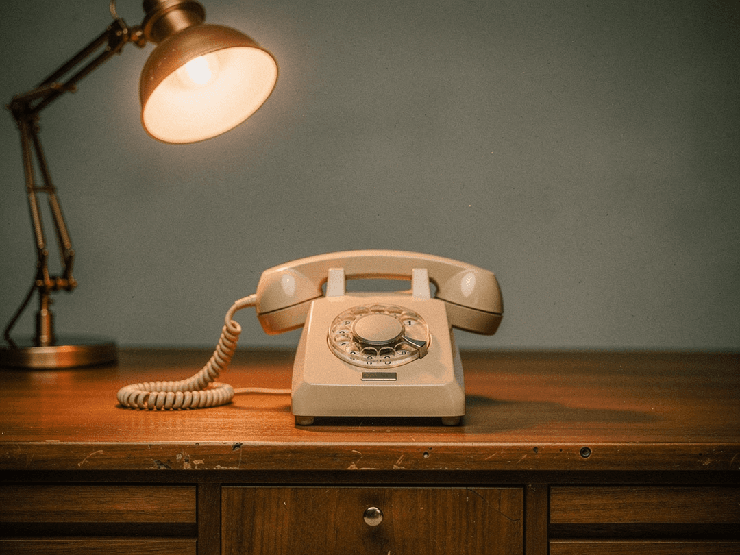Vintage rotary telephone on a retro office desk